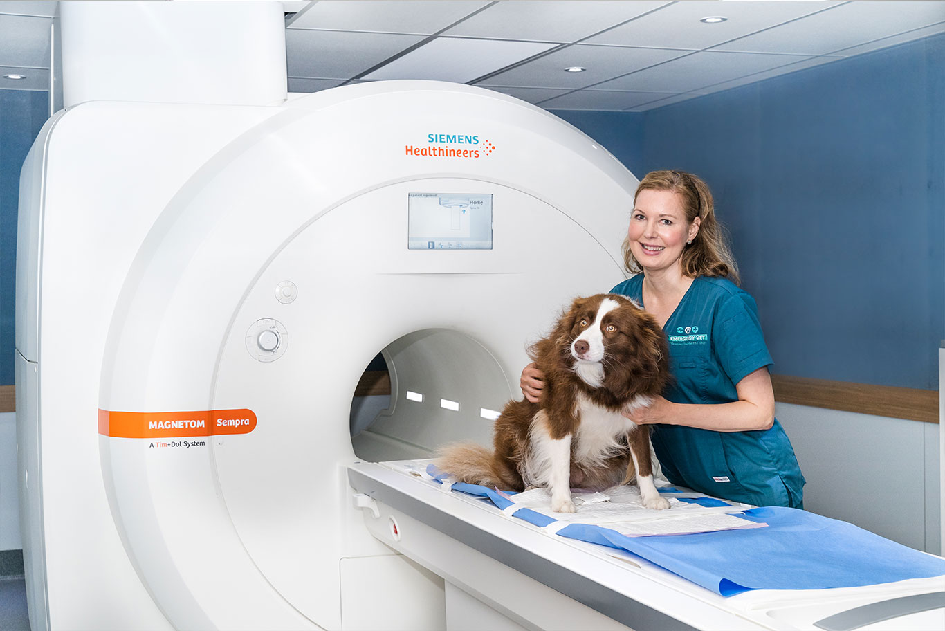 Dog with vet on MRI scanner machine